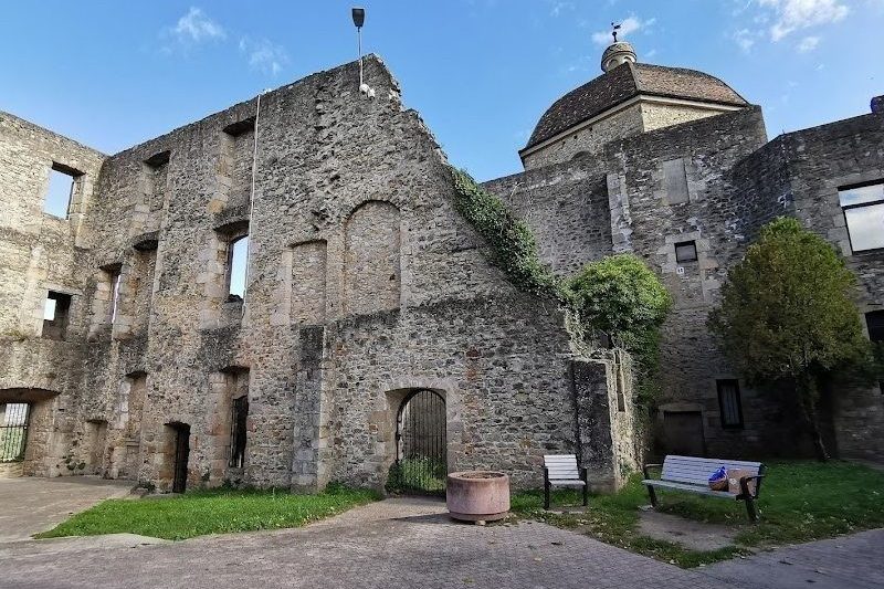 Courtyard of Aubenas castle beneath a blue sky